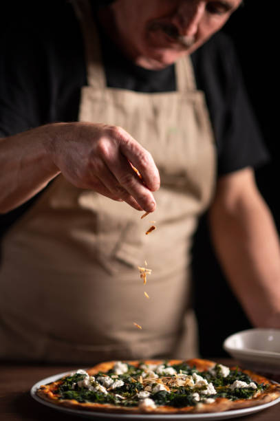 istock A male chef decorating a pizza 1454475504