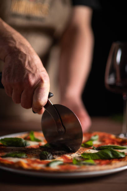 istock A male chef slicing a pizza 1454475534