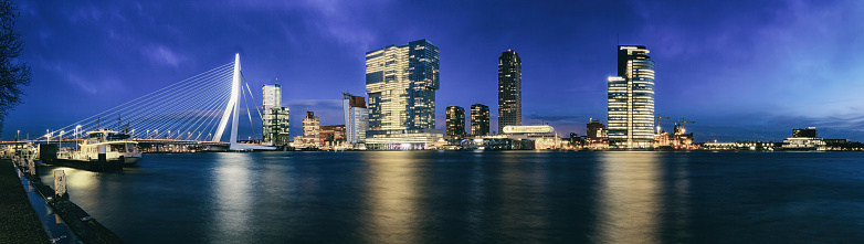Evening cityscape, panorama, banner - view of Rotterdam with Tower blocks in the Kop van Zuid neighbourhood and Erasmus Bridge, The Netherlands, 27 December, 2017