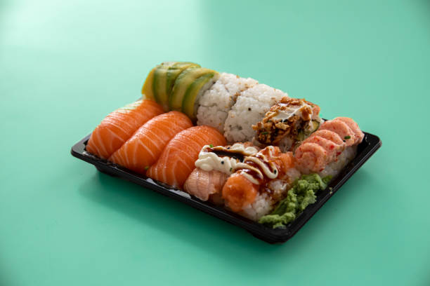 istock take away sushi package isolated on cyan background 1454479435