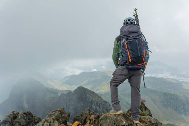 istock Man hiking at mountains with backpack 1454480228