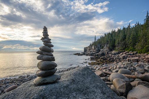 A rock stack known as a cairn trail marker along the Maine coastline