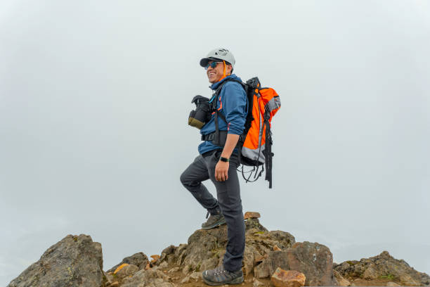 istock man hiker with backpack in front of a mountain 1454480483
