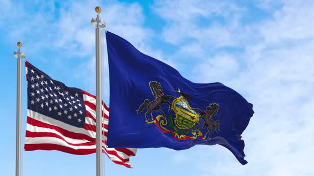 Pennsylvania state flag waving alongside the national flag of the United States