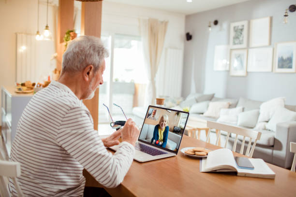 istock Senior man talking to his wife over a video call 1454483043