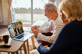 Senior couple talking to their counsellor over a video call