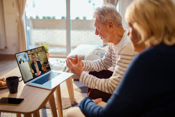 Senior couple talking to their counsellor over a video call Close up of a senior couple talking to their counsellor over a video call group of people men mature adult serious stock pictures, royalty-free photos & images