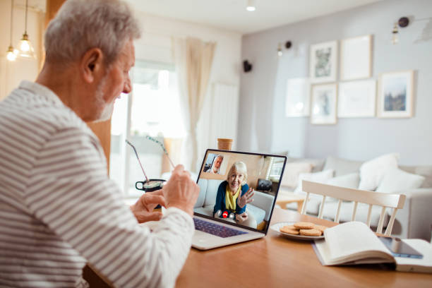 istock Senior man talking to his wife over a video call 1454483215