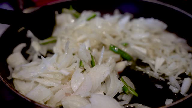 Stirring Fresh Sliced White Onions In Saucepan With Green Chilies. Slow Motion, Close Up