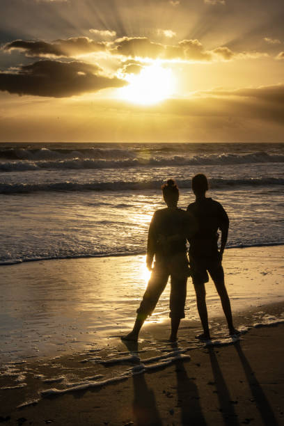 ID: 1454485162

Canova sunrise 3. A hetrosexual couple is observing the sunrise on a Florida beach. Rays of the sun through clouds and surf are visible.
Indian Harbor Beach, Florida, USA
12/02/2022 robert michaud stock pictures, royalty-free photos & images