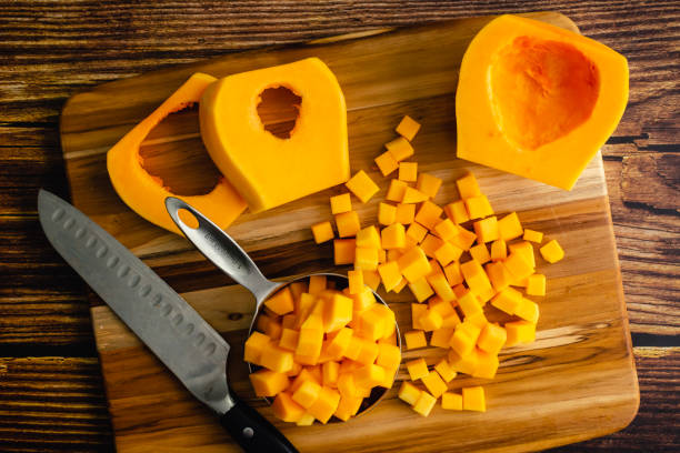 istock Butternut Squash Cut Into Small Cubes on a Wood Cutting Board 1454486843