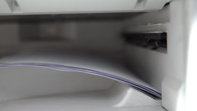 Close up of paper sheets, coping or printing on a printer or photo copier in business office