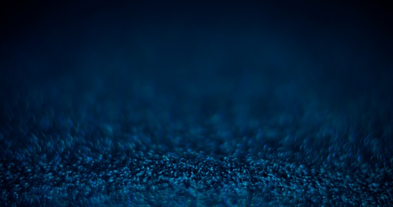 Blur color glow. Placement background. Night light flare. Defocused neon blue shiny sparkles on dark black abstract grain texture copy space wallpaper.