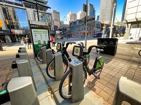 toronto, canada - 24 October 2022: bicycles parked on the city street at the station of a bicycle sharing system