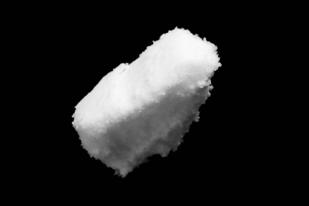 istock White snow isolated on black background close up 1454498259