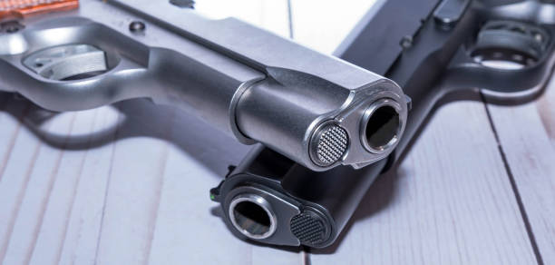 istock 1911 pistol muzzles on a white background 1454498387
