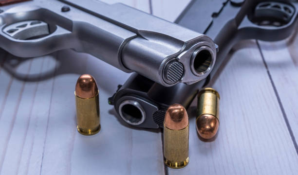 istock Two 1911 pistols with three bullets for them 1454498396