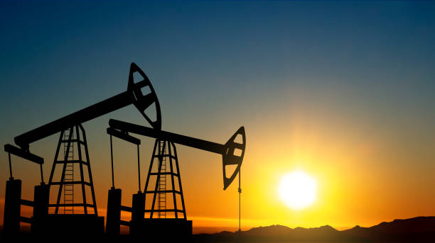 Silhouette of Oil pump. Industrial machine for petroleum on background of sunset Silhouette of Oil pump. Industrial machine for petroleum on background of sunset oil derrick crane crane exploration stock pictures, royalty-free photos & images