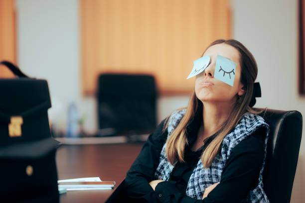 Funny businesswoman being bored playing with sticky notes