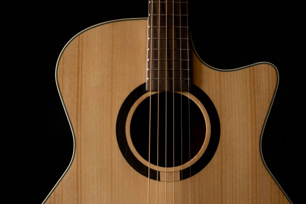 istock Classic Acoustic GA guitar with Satin Finished close up, dramatically lit on a black background with copy space 1454509663
