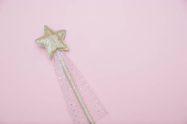 istock Magic wand, festive decoration, bright silver star with shine on soft pink background with copy space. Banner for website. Minimal holiday concept. 1454511641