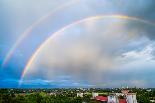 Double rainbow with local village, Chiang Mai province.