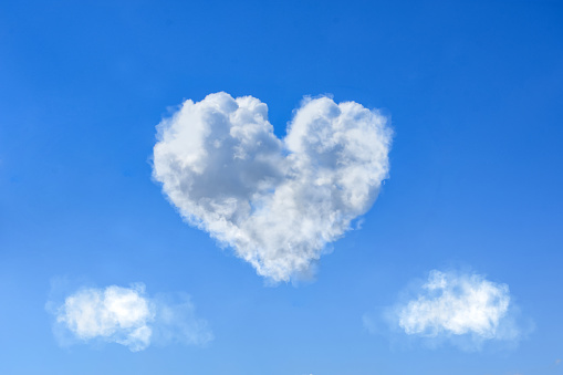 Heart shaped white clouds on bright blue sky during daytime, Valentines day concept