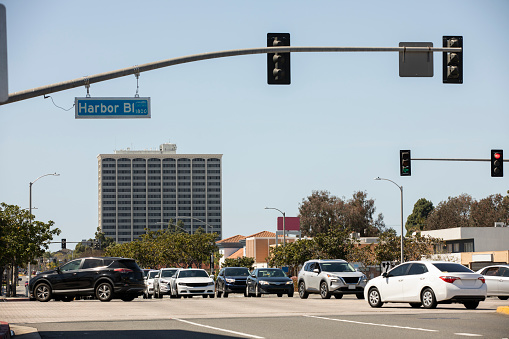 Morning traffic passes through downtown Costa Mesa, California, USA.