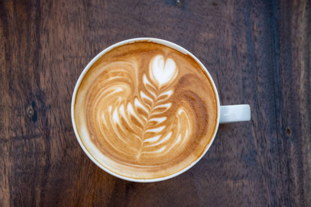 istock Latte art coffee cup on wooden table, top view 1454519725