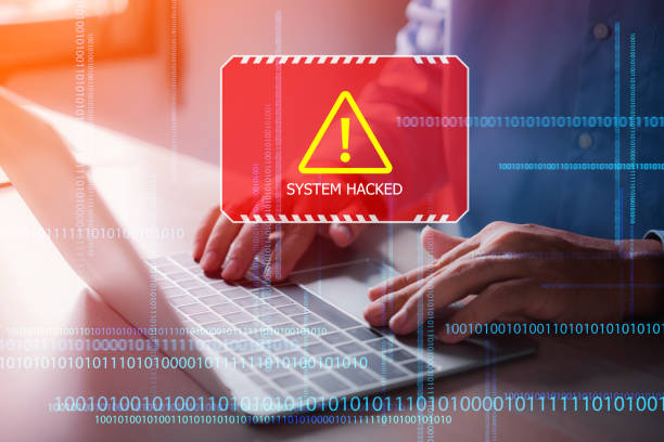 istock male hands on computer laptop got a red warning system hacked on the virtual digital screen 1454520162