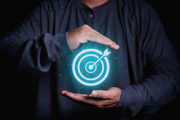 istock man hand holding target dart in the middle 1454520180