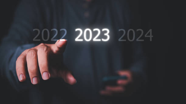 istock The guy selects year 2023 hi-light from the options on the virtual screen 1454520344