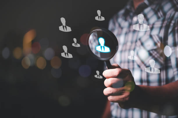 istock man hand holding magnifier searching person icon on screen 1454520737