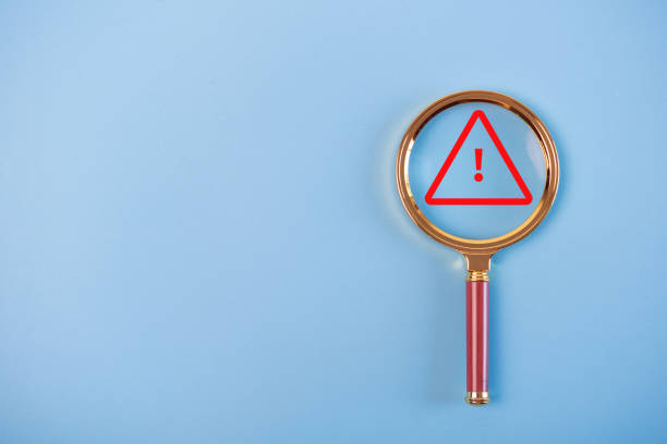 istock exclamation mark in magnifying glass on blue background 1454520754