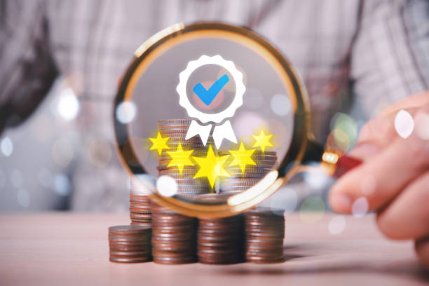 Male hand using a magnifying glass found five star satisfaction sign with coins stack background