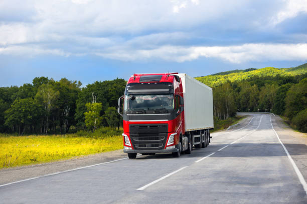 istock Red truck on a road in summer 1454523840
