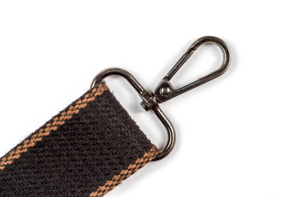 Metal carabiner on the belt. Carabiner clasp on a white background.