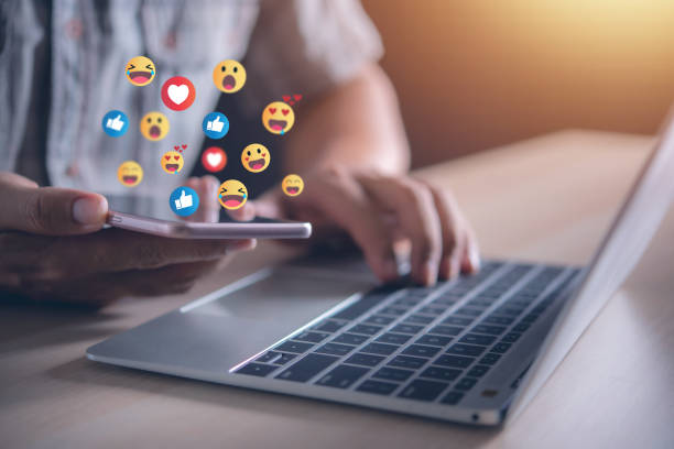 istock man hand using smartphone with social media emoticons pop up from screen , social media and digital online concept 1454524851