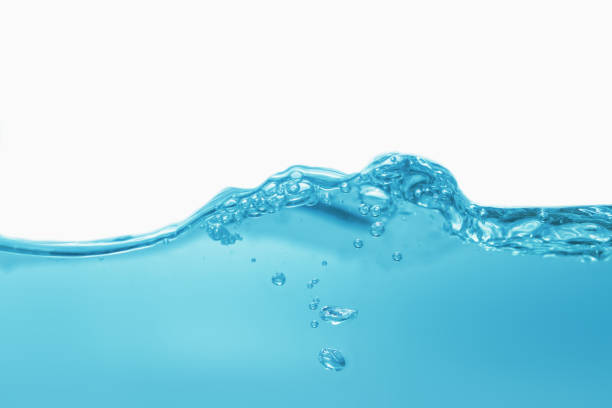istock Water waves cause bubbles and splatter in clear blue water. 1454525938