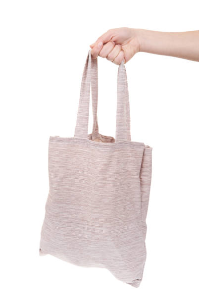 istock Girl holding fabric shopping bag isolate white background. 1454528182