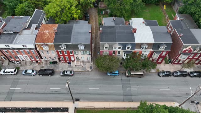 Rowhouses, homes and urban living in USA. City life in dangerous low income community. Aerial truck shot.