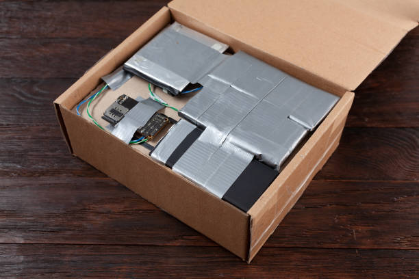 istock Hand made bomb with c4 and cell phone module in a cardboard box 1454529413