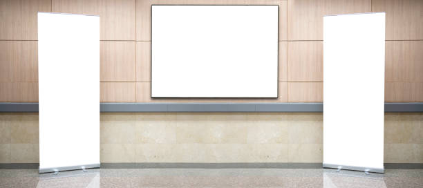 istock A large, blank billboard is mounted on the wall between the corridors. 1454530200