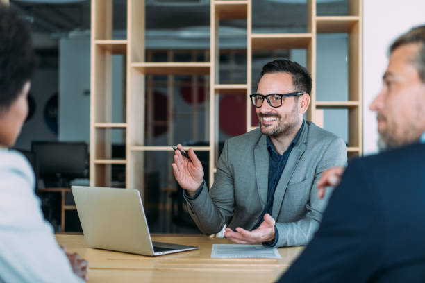 istock Group of business persons talking in the office. 1454530395