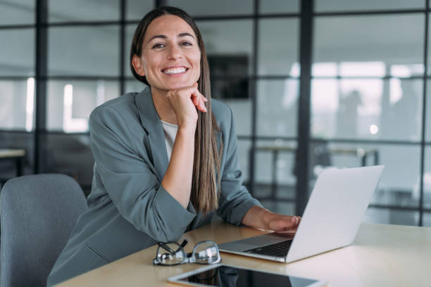 istock Successful businesswoman in modern office working on laptop. 1454530408