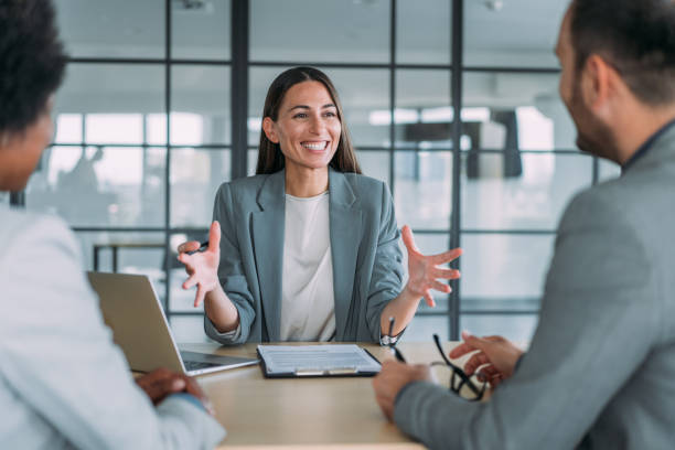 Group of business persons talking in the office. Shot of group of business persons in business meeting. Three entrepreneurs on meeting in board room. Corporate business team on meeting in modern office. Female manager discussing new project with her colleagues. Company owner on a meeting with two of her employees in her office. human resources stock pictures, royalty-free photos & images