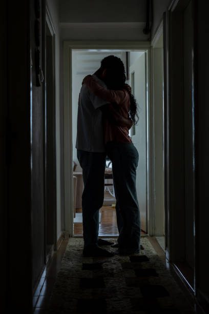 istock Husband and wife embracing each other at home 1454530583
