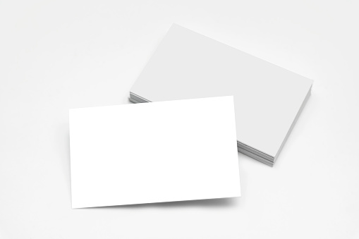 Business card mock up. Empty white business card stack on light desktop. Info, address and message concept. Mock up, 3D Rendering