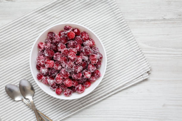 istock Red Sugared Cranberries in a Bowl, top view. Flat lay, overhead, from above. Space for text. 1454534216