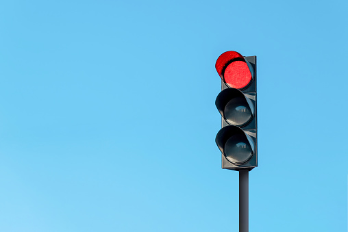 Traffic light and a camera on blue sky background. Traffic control concept.